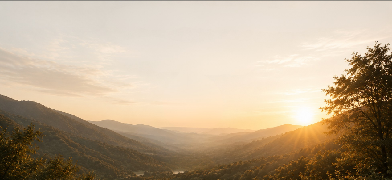 Golden sunset over misty mountain valley